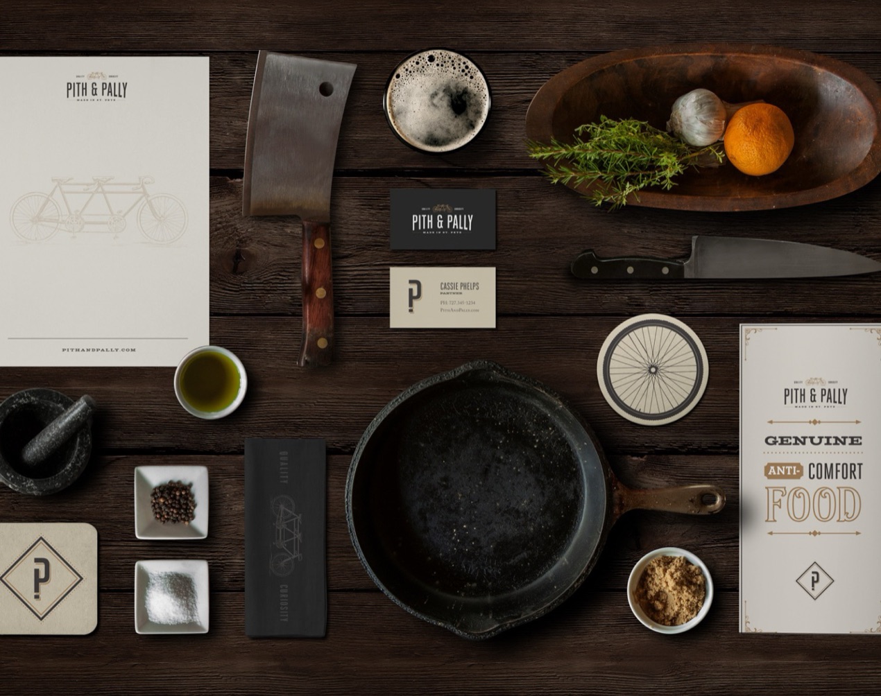Pith & Pally stationery and menu on a dark wood table